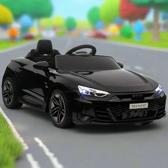 Black Audi RS e-tron GT kids ride-on car with LED lights on a toy road