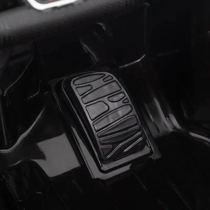 Close-up of black pedal in 12V Audi RS e-tron GT kids ride-on car interior