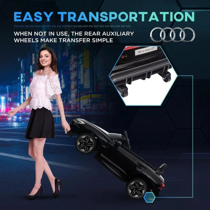 Woman transporting black 12V Audi RS e-tron GT kids ride-on car with rear wheels
