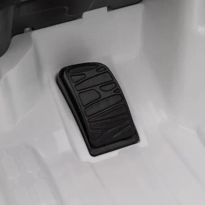 Close-up of black pedal inside white 12V Audi RS e-tron GT kids ride-on car