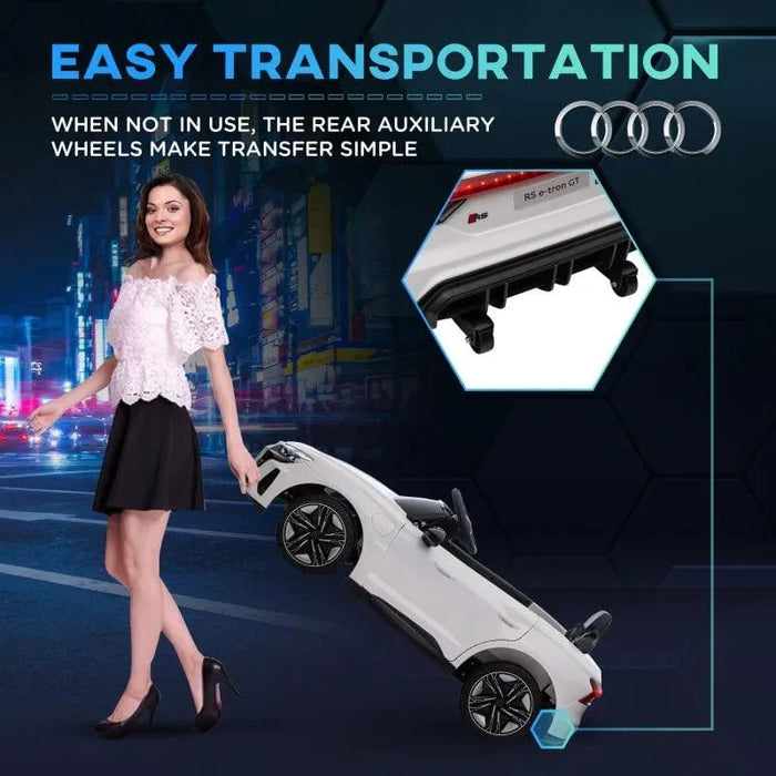Woman pulling white 12V Audi RS e-tron GT kids ride-on car with rear wheels, city background