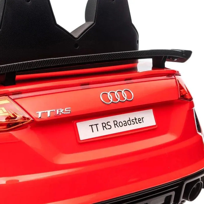 Red Audi TT RS Roadster kids electric ride-on car rear view with visible logo and spoiler