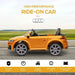 Yellow Audi TT RS kids ride-on car with remote control on a road, outdoor background