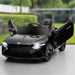 12V black Bentley Bacalar kids electric ride-on car with butterfly doors open, outdoors