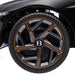 Close-up of black Bentley Bacalar kids ride-on car wheel with metallic bronze trim