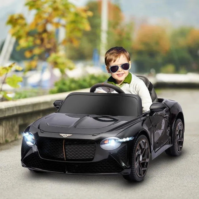 Child driving a black 12V Bentley Bacalar kids electric ride on car with butterfly doors