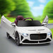 White 12V Bentley Bacalar kids electric ride-on car with open butterfly doors on road