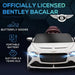 White 12V Bentley Bacalar kids electric ride-on car with butterfly doors, headlights on.