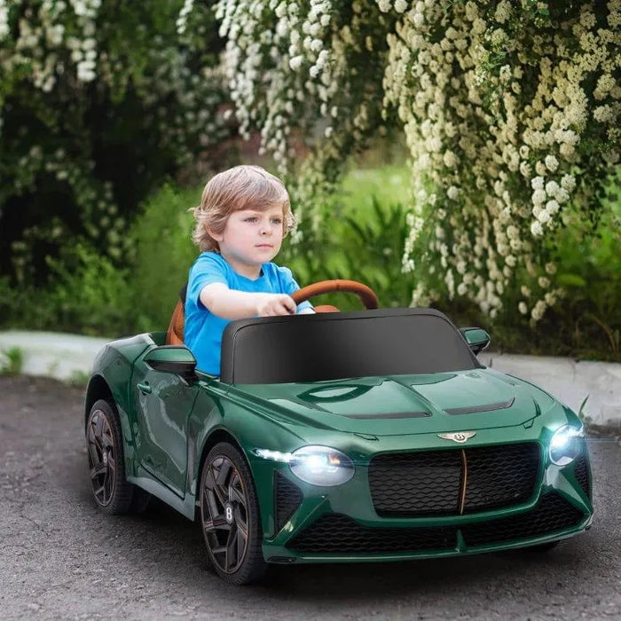 Child driving green Bentley Bacalar 12V kids ride-on car outdoors with flowers
