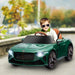 Child driving green 12V Bentley Bacalar kids ride-on car with sunglasses outdoors