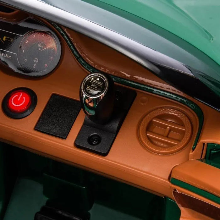 Dashboard of green 12V Bentley Bacalar kids ride-on car with red power button and controls