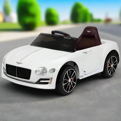 12V white Bentley kids electric ride-on car with black wheels on outdoor pavement
