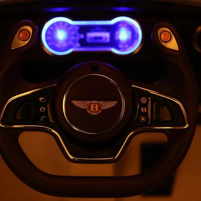 Illuminated dashboard and steering wheel of a 12V Bentley kids electric ride on car