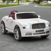 White 12V Bentley Mulsanne kids ride on car with chrome wheels, headlights on, outdoors.