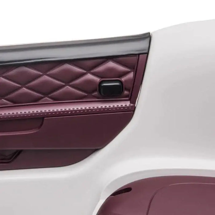 Diamond-stitched maroon door panel of a white kids Bentley Mulsanne ride-on car