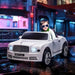 Child in white Bentley Mulsanne kids ride-on car with lights, city street background at night