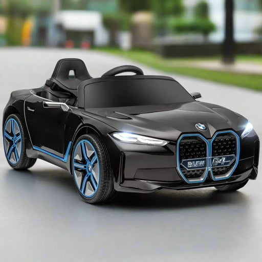 12V black BMW i4 kids electric ride-on car with blue accents on a road