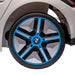 Close-up of BMW i4 kids ride on car blue and black wheel and fender, white body