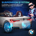 White 12V BMW i4 kids ride-on car with suspension system and a boy wearing sunglasses