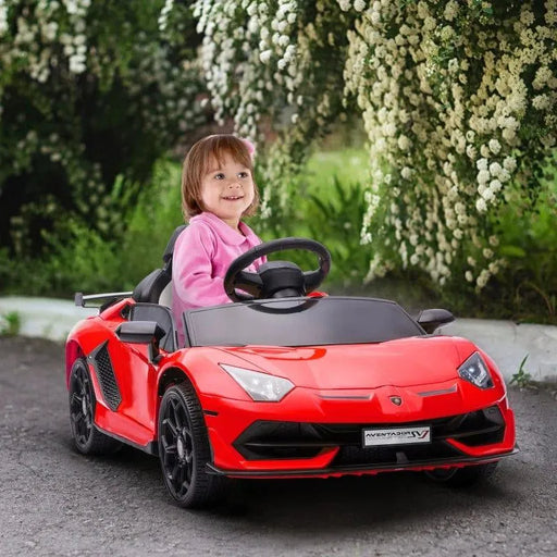 Child riding a red 12V Lamborghini Aventador kids ride-on car outdoors with flowers in background