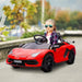 Child driving red 12V Lamborghini Aventador kids ride-on car with butterfly doors outdoors