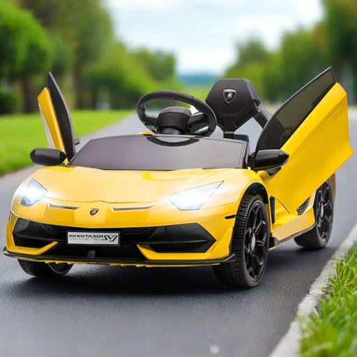 Yellow 12V Lamborghini Aventador kids ride-on car with butterfly doors open on outdoor road