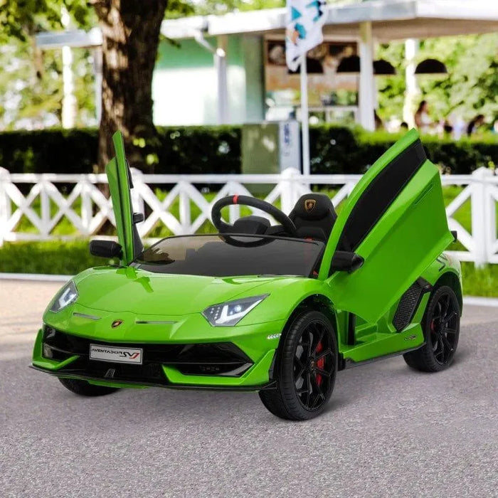 Green 12V Lamborghini Aventador SVJ kids ride on car with open scissor doors outdoors