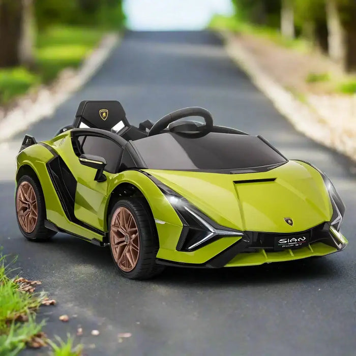 Green 12V Lamborghini Sian kids electric ride-on car with gold wheels on outdoor road