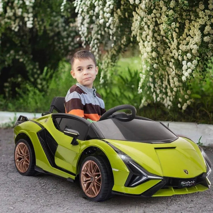 Child in green Lamborghini Sian kids electric ride-on car, outdoors with flowering bushes