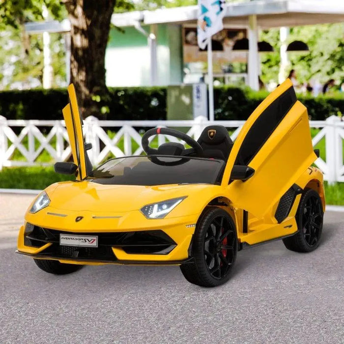 Yellow kids' electric Lamborghini SVJ ride-on car with LED lights and open scissor doors outdoors