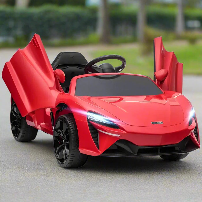 Red 12V licensed McLaren kids ride on car with butterfly doors open on outdoor pavement