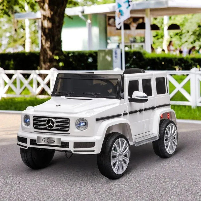 12V white Mercedes-Benz G500 kids electric ride-on jeep with LED lights, parked outdoors