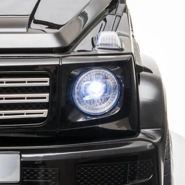 Black Mercedes-Benz G500 kids ride on jeep close-up with bright headlight