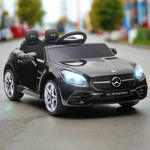 Black Mercedes-Benz SLC 300 kids electric ride-on car with LED lights on city street