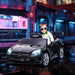 Child in sunglasses driving black 12V Mercedes-Benz SLC 300 kids electric ride-on car at night