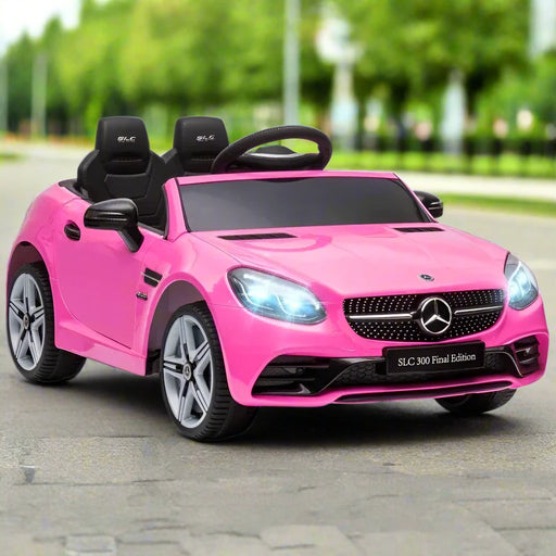 Pink Mercedes-Benz SLC 300 kids electric ride-on car on outdoor pavement