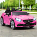 Pink Mercedes-Benz SLC 300 kids electric ride-on car on outdoor pavement