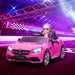 Child in pink 12V Mercedes-Benz SLC 300 kids electric ride-on car on a futuristic racetrack