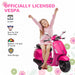 Happy child sitting on pink officially licensed Vespa electric ride-on scooter for kids