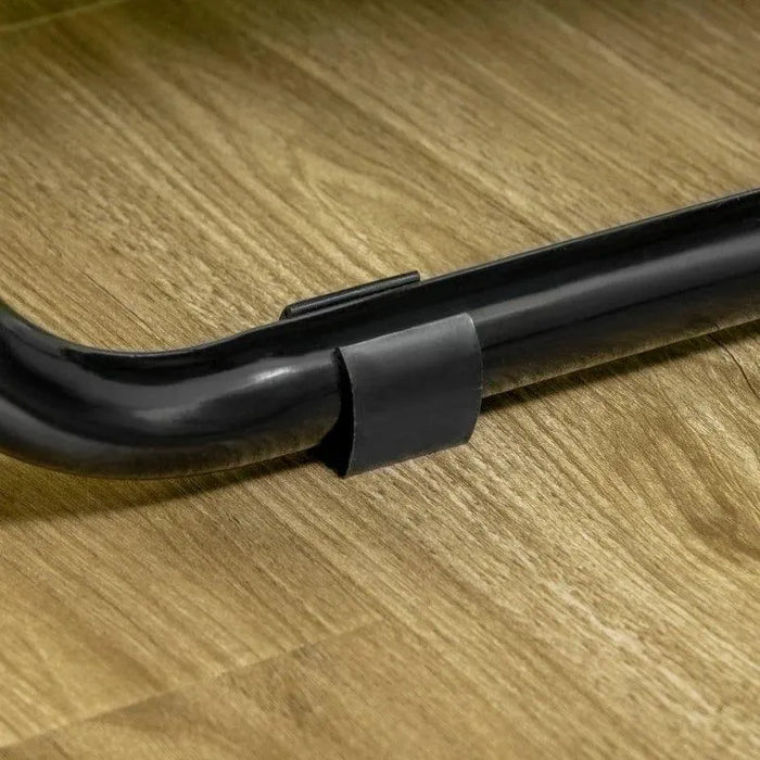 Close-up of a black trampoline frame base on wooden floor, springless bungee design