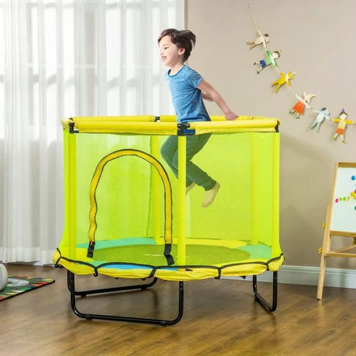 Child jumping on yellow indoor square bungee trampoline with safety net in playroom