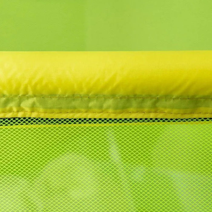 Close-up of yellow padded edge and green mesh net on kids indoor trampoline.