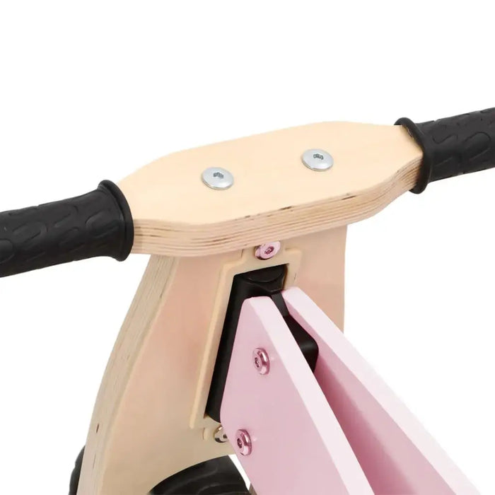 Close-up of pink and black 2-in-1 convertible balance bike with adjustable handlebar