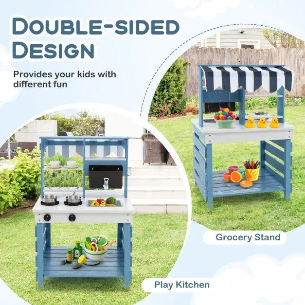 Double-sided blue mud kitchen with fabric canopy, play kitchen and grocery stand outdoors.