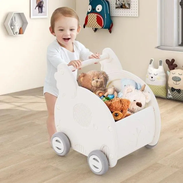 Baby pushing elephant-shaped 2-in-1 walker and shopping cart filled with stuffed animals