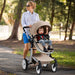 Woman pushing a stroller with a child in a park