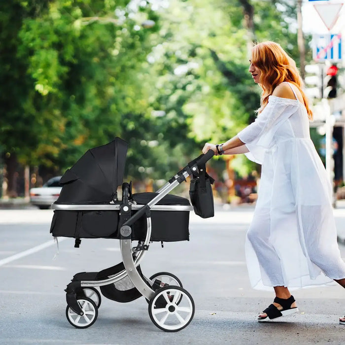 Woman pushing a stroller on a street with trees in the background