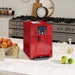 Red coffee machine on a kitchen counter with fruit and kitchen appliances in the background