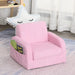 Pink 2-in-1 kids chair with side book pocket in cozy playroom setting