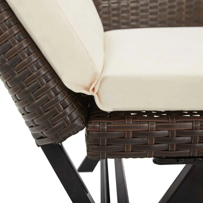 Close-up of rattan outdoor bench or day bed with cream cushion and black metal legs